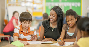 image of teacher talking with student team