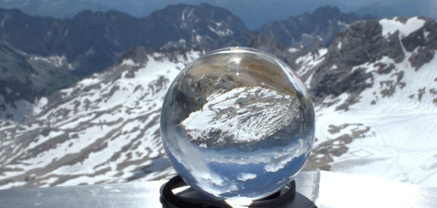 image of clear snowglobe in front of alpine habitat